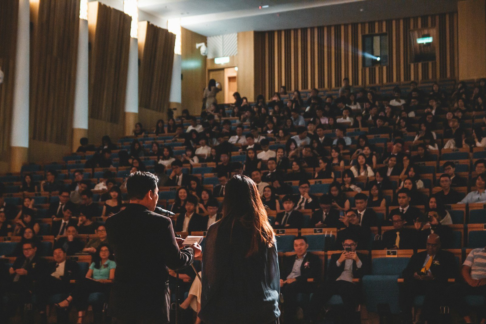Speaker addressing an audience; illustrative stock photo, not a confirmed conference speaker.