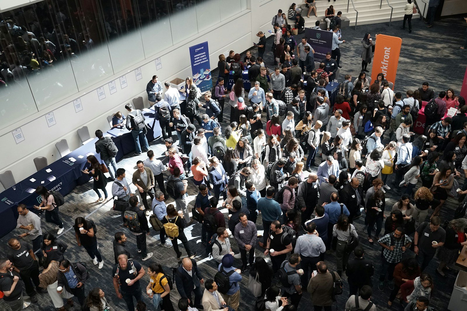 People gathering in a conference lobby; illustrative stock photo.