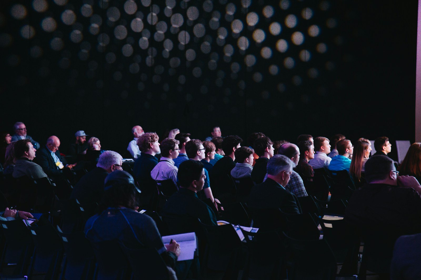 People talking at a conference; illustrative stock photo.